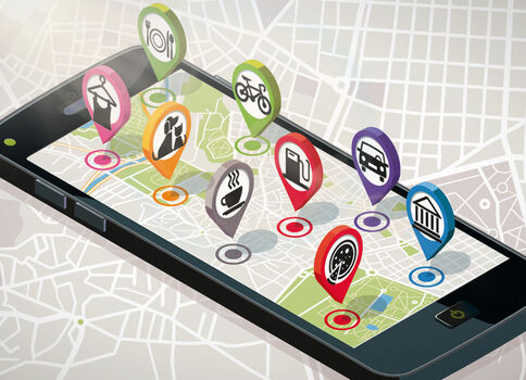 Ein Smartphone zeigt eine Kartenansicht mit bunten Markern, die verschiedene Orte markieren.