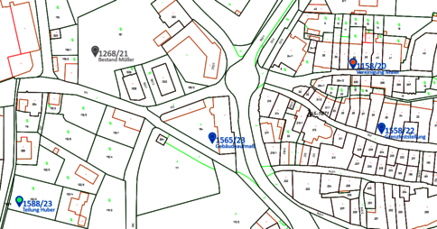 Detailreiche Karte eines Ortsteils mit Straßennetz, Grundstücksgrenzen und Gebäuden. Mehrere grüne Flächen sind sichtbar. Blaue Marker kennzeichnen verschiedene Standorte mit Nummern. Der Kartenausschnitt zeigt enge Bebauung und Parzellen rund um eine Straßenverzweigung.
